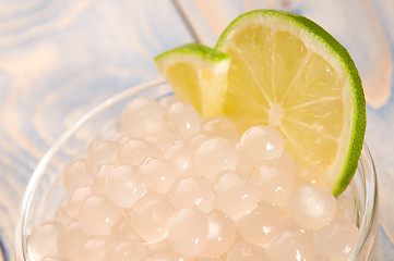 Image showing tapioca pearls with lime. white bubble tea ingredients