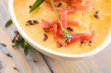 Image showing fresh melon soup with parma ham and lavender flower