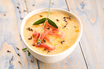 Image showing fresh melon soup with parma ham and lavender flower