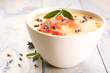 Image showing fresh melon soup with parma ham and lavender flower