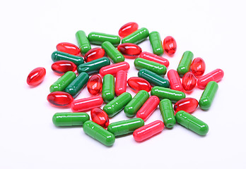 Image showing Red and green pills on white background 