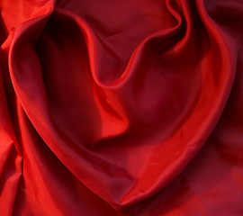 Image showing Red heart from elegant red silk as background