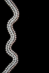 Image showing White and pink pearls on the black silk 