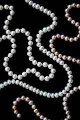 Image showing White and pink pearls on the black silk 