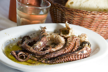 Image showing marinated octopus with house wine Greek Island taverna specialty