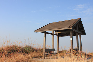 Image showing pavilion on the grassland with blue sky. 