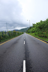 Image showing Long road stretching out into the distance under a dramatic blue