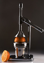 Image showing Chrome Citrus Juicer and Orange Halves