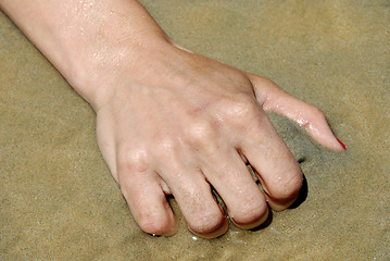 Image showing Hand grabbing sand