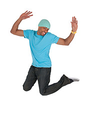 Image showing Smiling guy in a blue t-shirt jumping for joy