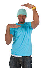 Image showing Guy in a blue t-shirt making a frame with his arms