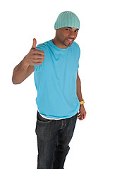 Image showing Smiling young man in a blue with thumb up