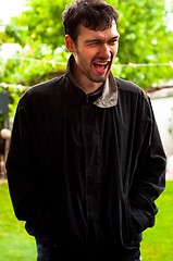 Image showing Young man laughing on a joke outdoors