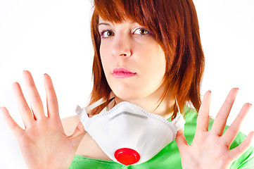 Image showing Beautiful young girl holding protective mask