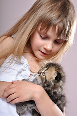 Image showing child cuddling  a kitten