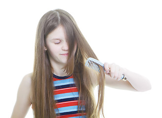 Image showing Teen girl combing her long hair