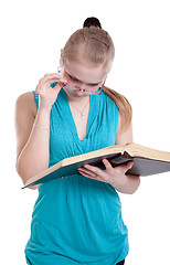 Image showing A young girl in glasses with a book