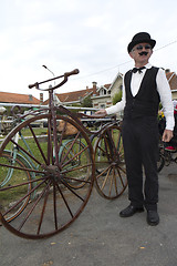 Image showing Biker with an old bicycle.