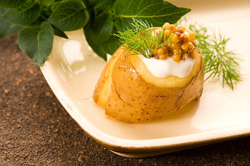 Image showing Baked potato with sour cream, grain Dijon mustard and herbs