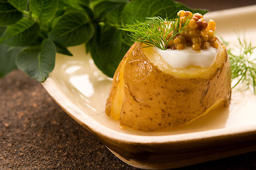 Image showing Baked potato with sour cream, grain Dijon mustard and herbs