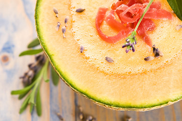 Image showing fresh melon soup with parma ham and lavender flower