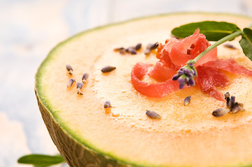 Image showing fresh melon soup with parma ham and lavender flower