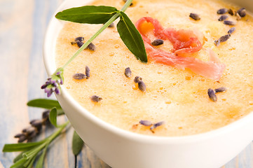 Image showing fresh melon soup with parma ham and lavender flower