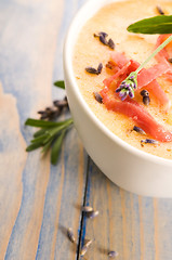 Image showing fresh melon soup with parma ham and lavender flower