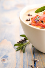 Image showing fresh melon soup with parma ham and lavender flower