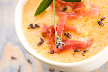 Image showing fresh melon soup with parma ham and lavender flower