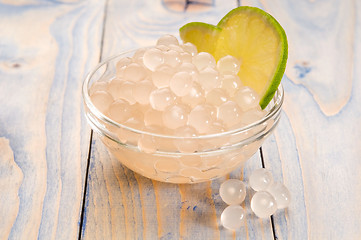 Image showing tapioca pearls with lime. white bubble tea ingredients