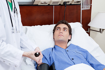 Image showing Doctor checking patient's blood pressure