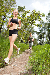 Image showing Friends jogging in a forest