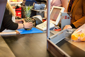 Image showing Midsection of shop assistant and customer