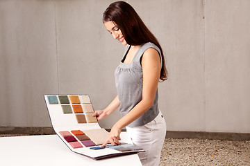 Image showing Interior Architect Choosing Rug Sample