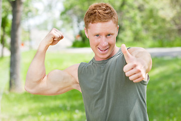 Image showing Man flexing and showing thumbs-up sign