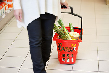 Image showing Woman in Supermarket pulling Basket