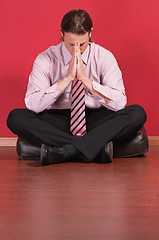 Image showing Business executive sitting on the floor