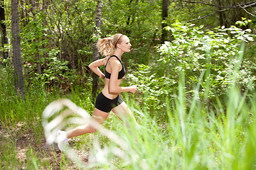 Image showing Woman running in the forest