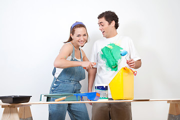 Image showing Woman painting color on her boyfriend's shirt