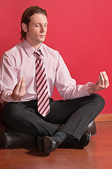 Image showing Smart businessman sitting in yoga lotus position