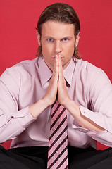 Image showing Thoughtful businessman with hand clasped