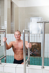 Image showing Mature man stepping out of the pool