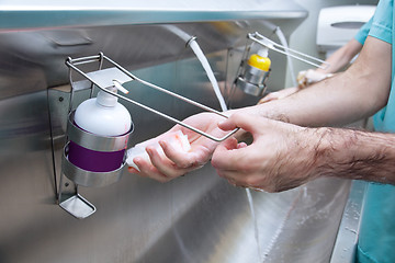 Image showing Man washing his hand with hand sanitizer