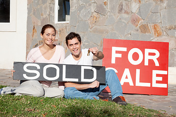 Image showing Happy young couple with key to their new house