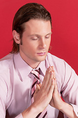 Image showing Closeup of a businessman in prayer posture