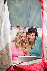 Image showing Couple working on laptop while camping