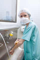 Image showing Medical woman in mask washing hands