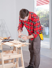 Image showing Man Using Electric Hand Sander