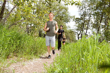 Image showing Friends exercising in forest track